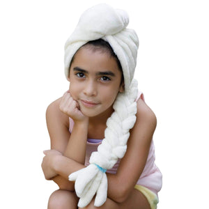young girl wearing white microfiber hair towel with braid feature sitting on the steps